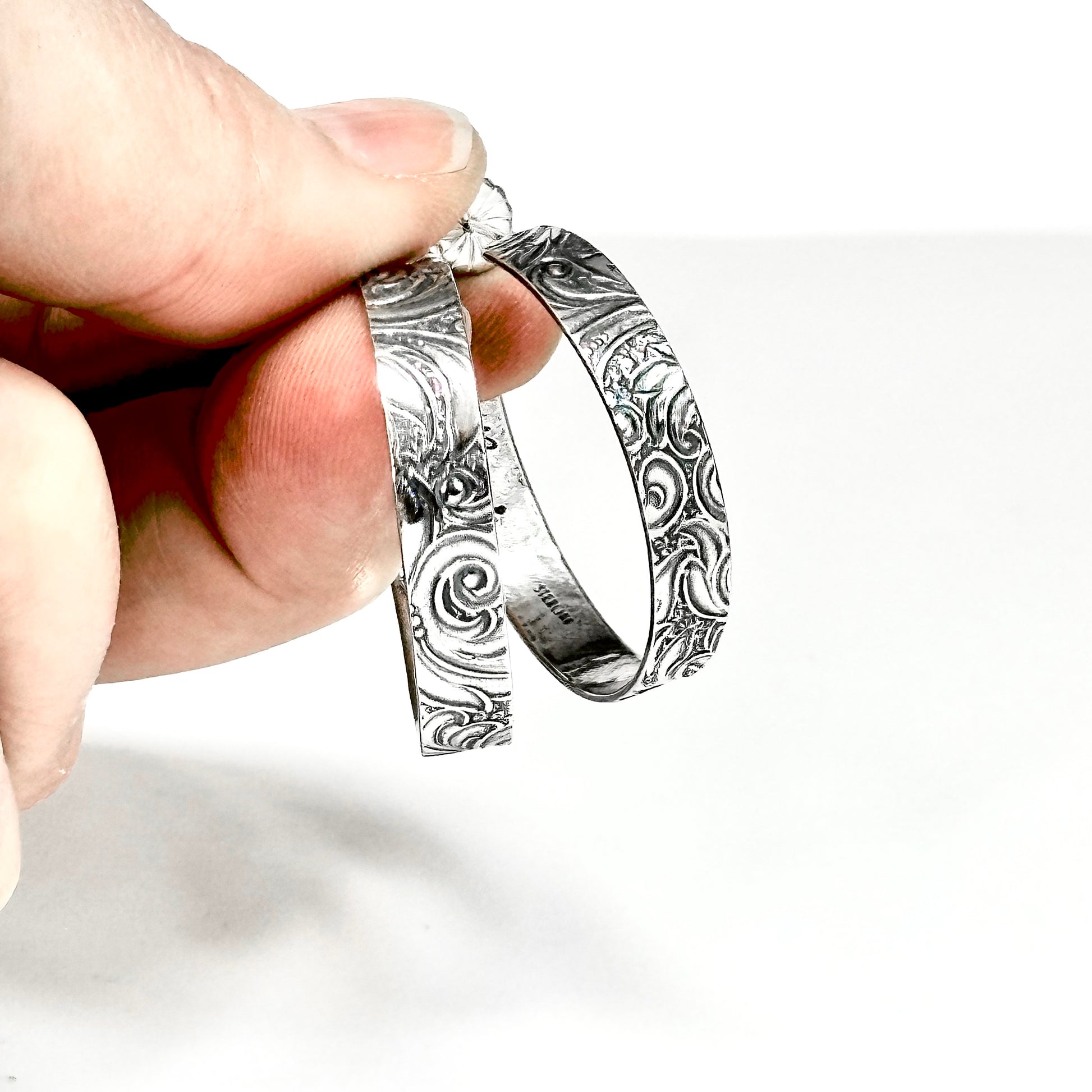 sterling silver post hoop earring with engraved scroll pattern impressed from a vintage scroll and swirl pattern. 1/4 inch wide by your choice of diameter, handmade earrings with push back by Hanni jewelry harbor springs, Michigan