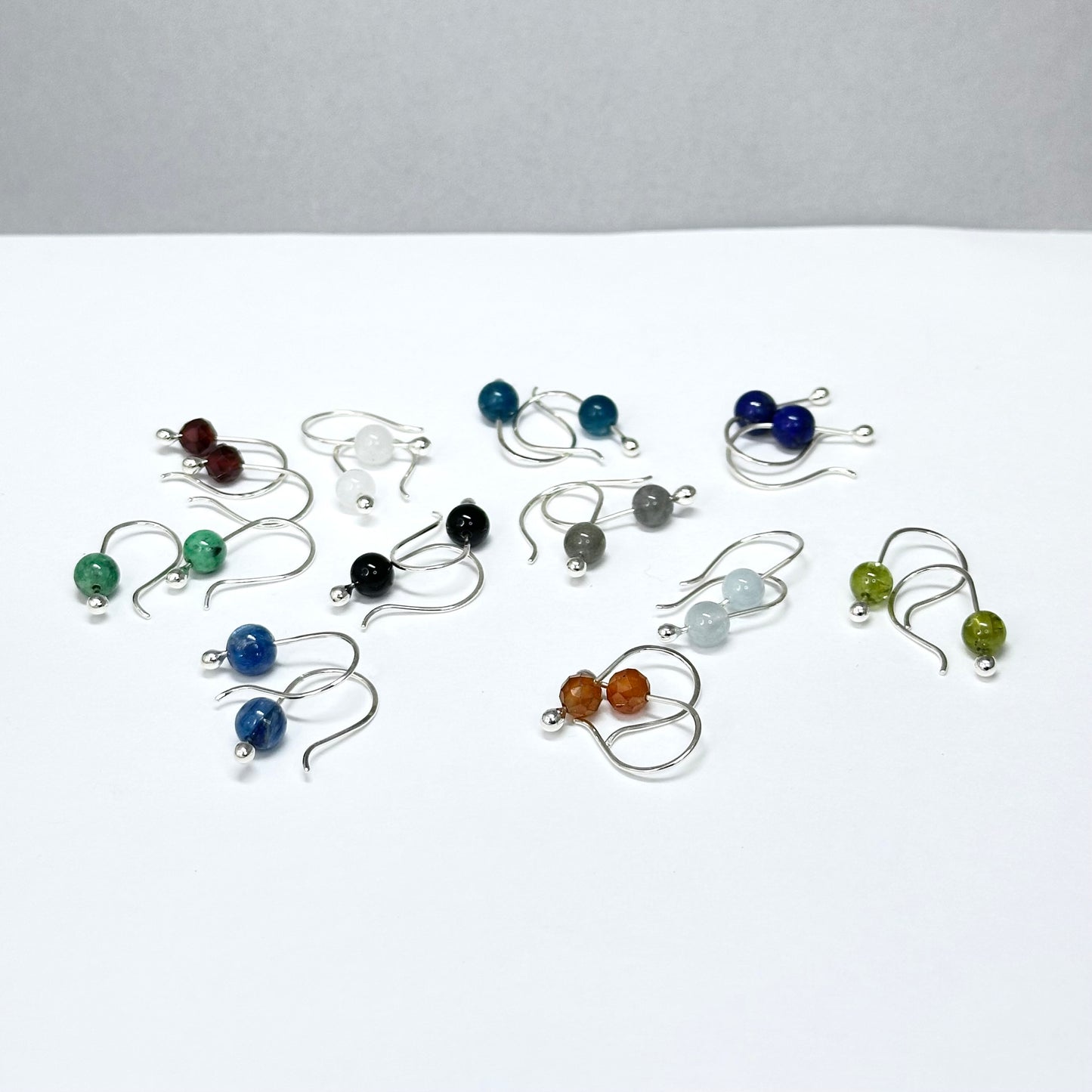 Simple small gemstone earring sterling silver hook ear wire with silver drop holding on stone, comes in apatite, lapis, moonstone, variscite, garnet, onyx and more. 6mm stones. Handmade jewelry by Hanni Jewelry, Harbor Springs, Michigan.