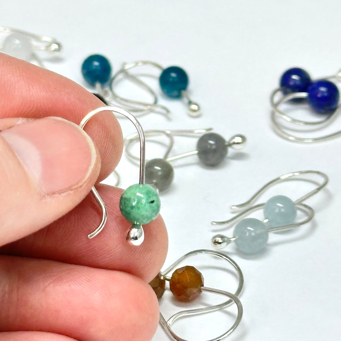 Simple small gemstone earring sterling silver hook ear wire with silver drop holding on stone, comes in apatite, lapis, moonstone, variscite, garnet, onyx and more. 6mm stones. Handmade jewelry by Hanni Jewelry, Harbor Springs, Michigan.