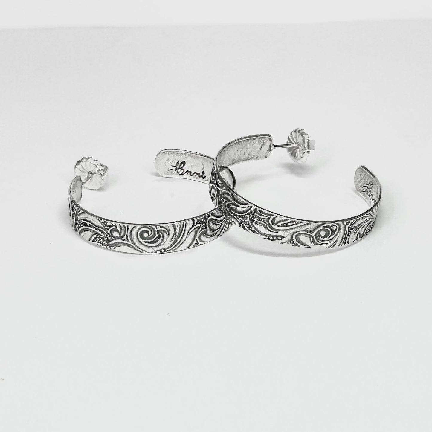 sterling silver post hoop earring with engraved scroll pattern impressed from a vintage scroll and swirl pattern. 1/4 inch wide by your choice of diameter, handmade earrings with push back by Hanni jewelry harbor springs, Michigan