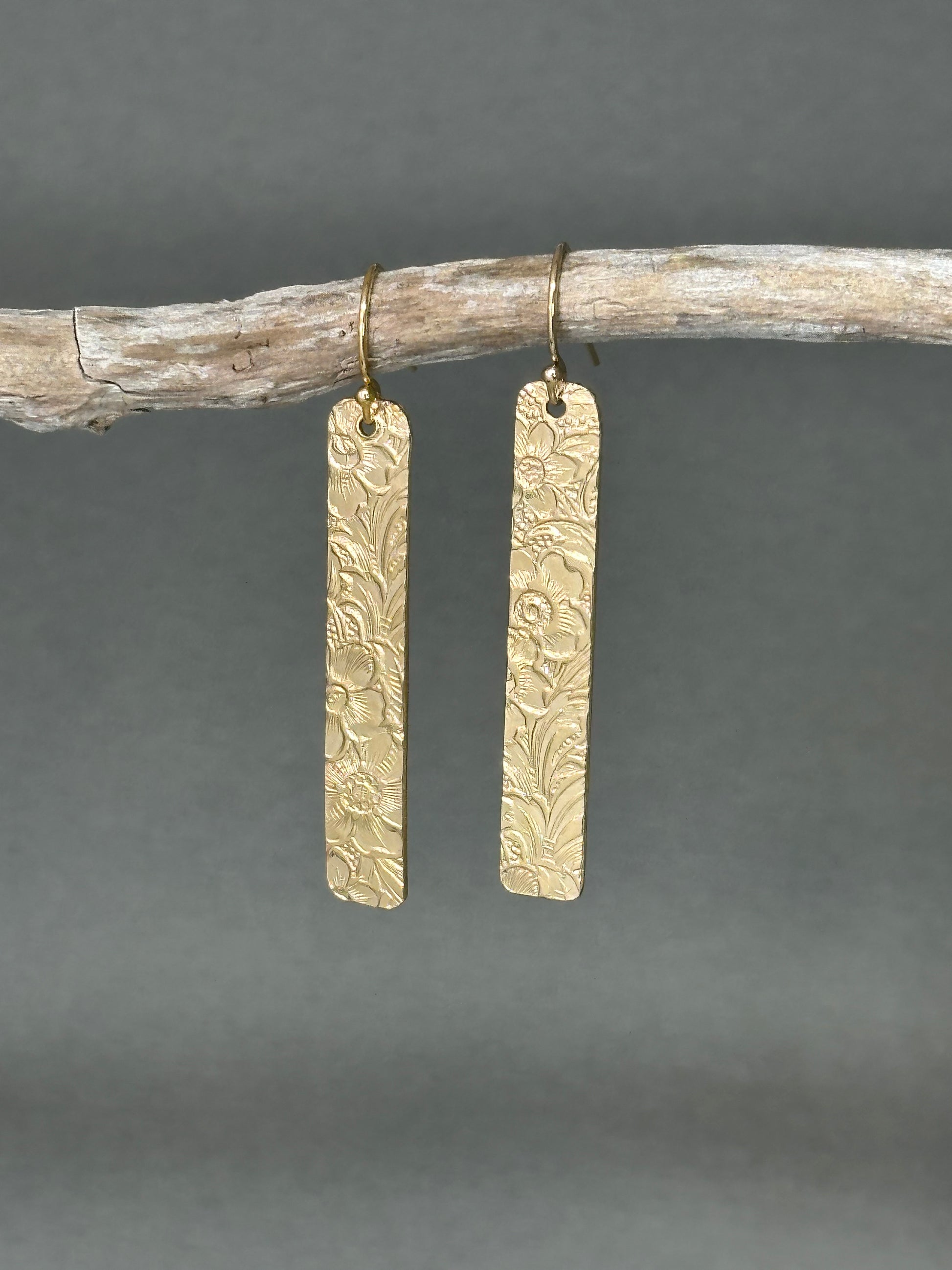 14kt gold filled or sterling bar dangle earrings with a 1/4 inch wide x 1.5 inch long bar with an embossed vintage floral pattern, hangs from standard ear wires or lever back hooks. hand crafted artisan jewelry by hanni jewelry, harbor springs, michigan.