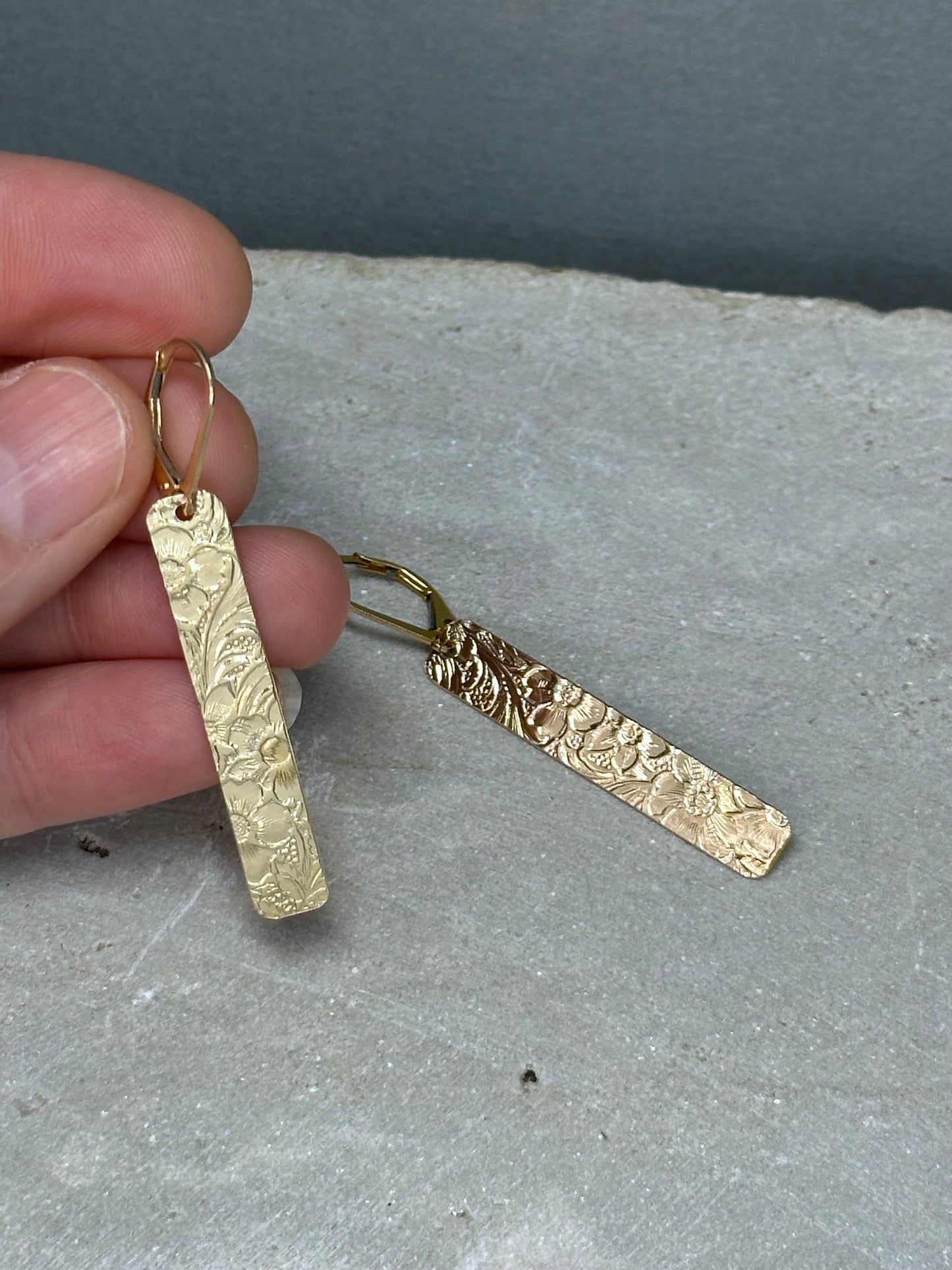 14kt gold filled or sterling bar dangle earrings with a 1/4 inch wide x 1.5 inch long bar with an embossed vintage floral pattern, hangs from standard ear wires or lever back hooks. hand crafted artisan jewelry by hanni jewelry, harbor springs, michigan.