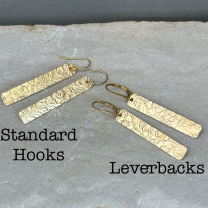 14kt gold filled or sterling bar dangle earrings with a 1/4 inch wide x 1.5 inch long bar with an embossed vintage floral pattern, hangs from standard ear wires or lever back hooks. hand crafted artisan jewelry by hanni jewelry, harbor springs, michigan.