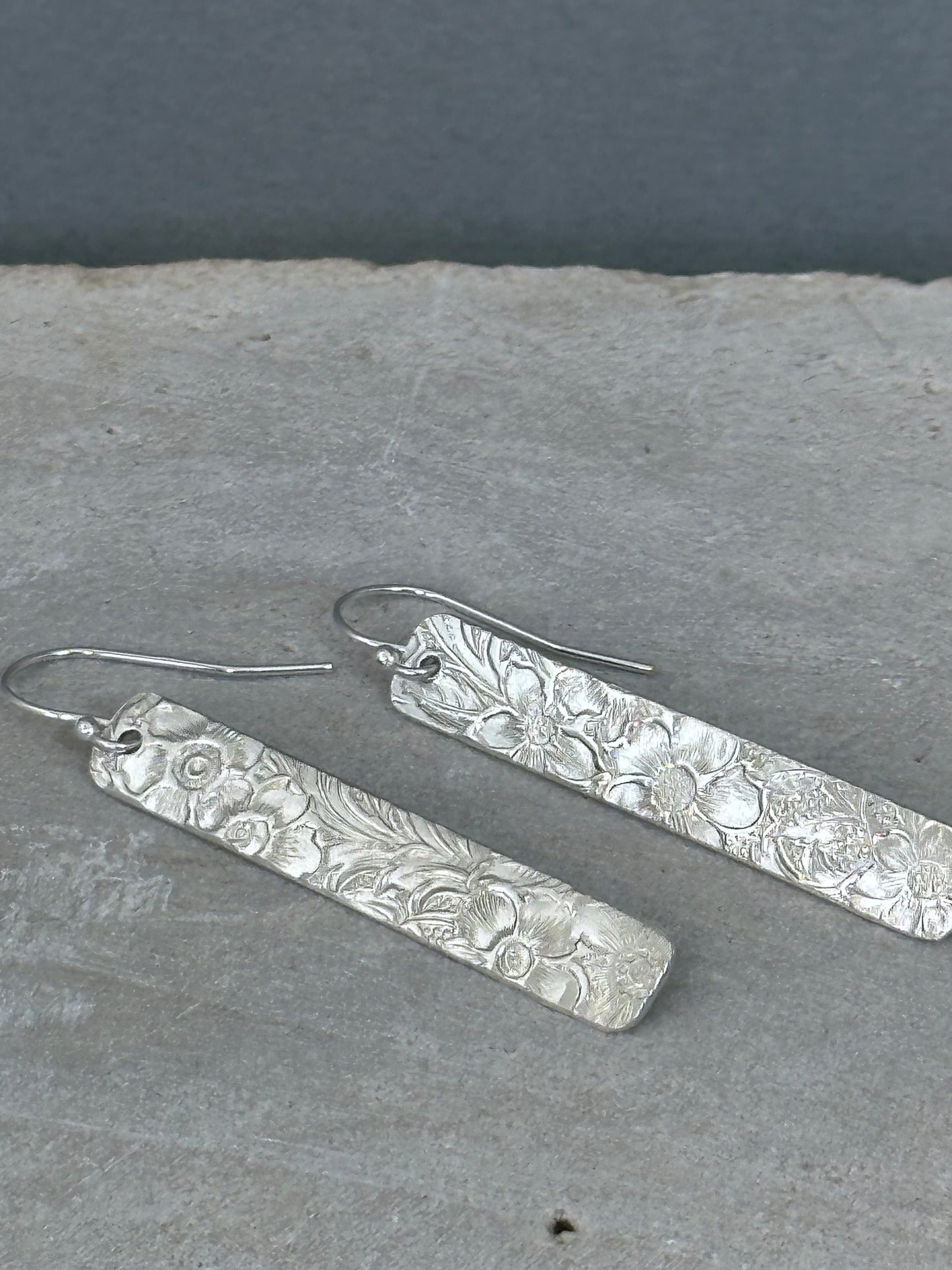 14kt gold filled or sterling bar dangle earrings with a 1/4 inch wide x 1.5 inch long bar with an embossed vintage floral pattern, hangs from standard ear wires or lever back hooks. hand crafted artisan jewelry by hanni jewelry, harbor springs, michigan.