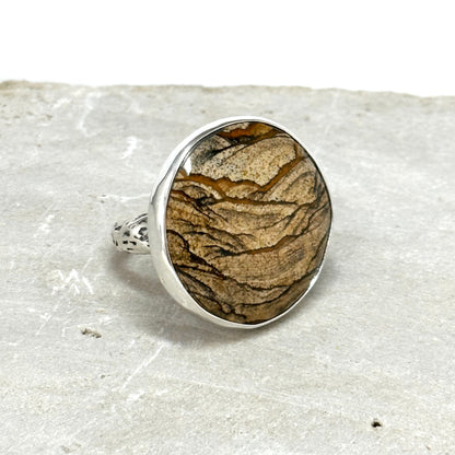 picture jasper statement ring sterling argentium and fine silver with carved branch ring band. stone is 1.25 inched in diameter. scenic jasper jewelry handmade sterling silver by Hanni jewelry, harbor springs, Michigan pure Michigan jewelry