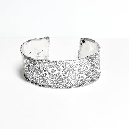 leaves and flower pattern cuff bracelet with melted edges made of argentium tarnish resistant silver 1 inch wide and 6 1/4 inches long one size fits most engraved flower jewelry handmade sterling silver by Hanni jewelry harbor springs Michigan